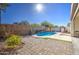 Inviting kidney-shaped pool with a stone deck and water feature at 5015 S Quantum Way, Mesa, AZ 85212