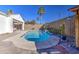 Beautiful kidney shaped pool surrounded by desert landscaping at 5015 S Quantum Way, Mesa, AZ 85212