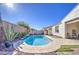 Relaxing kidney-shaped pool with a stone deck and water feature at 5015 S Quantum Way, Mesa, AZ 85212