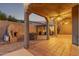 Evening view of backyard patio, fireplace, and outdoor kitchen at 5028 N Scottsdale Rd, Paradise Valley, AZ 85253