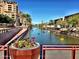 Picturesque canal view with colorful flowers and buildings at 5028 N Scottsdale Rd, Paradise Valley, AZ 85253