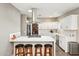 Modern kitchen with white cabinets, island, and stainless steel appliances at 5028 N Scottsdale Rd, Paradise Valley, AZ 85253