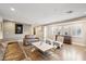 Bright living room featuring hardwood floors and comfy leather sofas at 5028 N Scottsdale Rd, Paradise Valley, AZ 85253