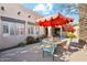 Inviting patio with red umbrella and seating for four at 5028 N Scottsdale Rd, Paradise Valley, AZ 85253