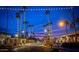 Evening view of town square with palm trees and lights at 5028 N Scottsdale Rd, Paradise Valley, AZ 85253