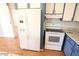 Kitchen with white appliances and blue cabinets at 513 W Melrose Dr, Casa Grande, AZ 85122