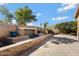 Landscaped backyard with stone fireplace and planters at 5415 W Pontiac Dr, Glendale, AZ 85308