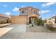 Two-story house with tan exterior, landscaped yard, and a two-car garage at 5415 W Pontiac Dr, Glendale, AZ 85308