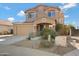 Two-story house with tan exterior, landscaped yard, and a two-car garage at 5415 W Pontiac Dr, Glendale, AZ 85308