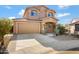 Two-story house with tan exterior, landscaped yard, and a two-car garage at 5415 W Pontiac Dr, Glendale, AZ 85308