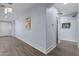 Bright hallway with wood-look floors and neutral wall paint at 5415 W Pontiac Dr, Glendale, AZ 85308