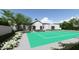 Private backyard featuring a green tennis court and landscaping at 5446 E Exeter Blvd, Phoenix, AZ 85018