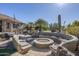 Landscaped backyard with fire pit and seating at 5500 N Globe Dr, Eloy, AZ 85131