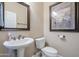 Small bathroom with pedestal sink and toilet at 5500 N Globe Dr, Eloy, AZ 85131