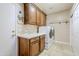 Convenient laundry room with washer, dryer, and cabinets at 5500 N Globe Dr, Eloy, AZ 85131