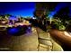 Night view of a backyard patio with fire pit and seating at 5500 N Globe Dr, Eloy, AZ 85131