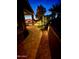 Backyard patio at night with lights and landscaping at 5500 N Globe Dr, Eloy, AZ 85131