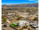 Aerial view of a modern home with a pool and putting green, mountain backdrop at 744 E Desert Ln, Phoenix, AZ 85042