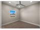 Simple bedroom with carpet and a window showcasing backyard view at 744 E Desert Ln, Phoenix, AZ 85042