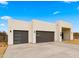 Two-car garage, neutral color home with clean lines and landscaping at 744 E Desert Ln, Phoenix, AZ 85042