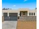 Modern stucco home with two-car garage and gated entry at 744 E Desert Ln, Phoenix, AZ 85042