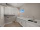 Laundry room with white cabinets and countertop at 744 E Desert Ln, Phoenix, AZ 85042