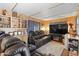 Relaxing living room featuring black leather reclining furniture and a large TV at 7807 E Main St # B-15, Mesa, AZ 85207