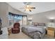 King bedroom with bay window, ceiling fan and relaxing armchair at 8500 E Southern Ave # 126, Mesa, AZ 85209