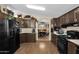 View of kitchen with dark wood cabinets and breakfast bar at 8500 E Southern Ave # 506, Mesa, AZ 85209