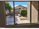 View of backyard through window; small patio and landscaping visible at 8605 W Paradise Dr, Peoria, AZ 85345