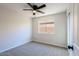 Spacious bedroom with ceiling fan and carpet at 8605 W Paradise Dr, Peoria, AZ 85345