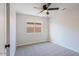 Well-lit bedroom with ceiling fan and carpet at 8605 W Paradise Dr, Peoria, AZ 85345