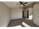 Spacious carpeted bedroom with ceiling fan and large closet at 8605 W Paradise Dr, Peoria, AZ 85345