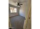 Spacious bedroom with ceiling fan, neutral carpeting, and window at 8605 W Paradise Dr, Peoria, AZ 85345