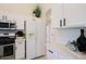 Modern kitchen with white cabinets, stainless steel appliances, and a pantry at 8605 W Paradise Dr, Peoria, AZ 85345