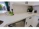 Kitchen with white cabinets, quartz countertops, and modern black handles at 8605 W Paradise Dr, Peoria, AZ 85345