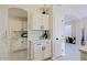 White kitchen with pantry, quartz countertops, and modern design at 8605 W Paradise Dr, Peoria, AZ 85345