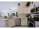 Bright kitchen with white cabinets, stainless steel appliances, and a corner sink at 8605 W Paradise Dr, Peoria, AZ 85345