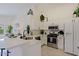 Modern kitchen with white cabinets, stainless steel appliances, and quartz countertops at 8605 W Paradise Dr, Peoria, AZ 85345