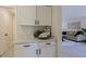 Bright laundry room with white cabinets and countertop at 8605 W Paradise Dr, Peoria, AZ 85345