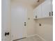 Bright laundry room with washer/dryer hookups and cabinets at 8605 W Paradise Dr, Peoria, AZ 85345