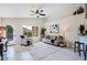 Living room with vaulted ceiling, comfy seating, and a large window at 8605 W Paradise Dr, Peoria, AZ 85345