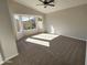 Main bedroom with bay window, carpet, and ceiling fan at 8605 W Paradise Dr, Peoria, AZ 85345