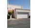 Front view of a light-colored townhouse with a red tile roof and attached garage at 8719 N Fountain Dr, Peoria, AZ 85345