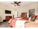 Spacious bedroom with a large TV, ceiling fan, and ample closet space at 900 S Canal Dr # 224, Chandler, AZ 85225