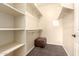 Walk-in closet with shelving and a cushioned ottoman at 900 S Canal Dr # 224, Chandler, AZ 85225