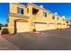 Tan colored stucco building with multiple attached garages at 900 S Canal Dr # 224, Chandler, AZ 85225