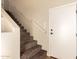 Carpeted stairs with a white handrail at 900 S Canal Dr # 224, Chandler, AZ 85225