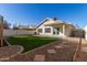 Landscaped backyard with covered patio and artificial turf at 901 N Longmore St, Chandler, AZ 85224