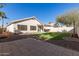 Artificial turf and stone backyard with covered patio at 901 N Longmore St, Chandler, AZ 85224